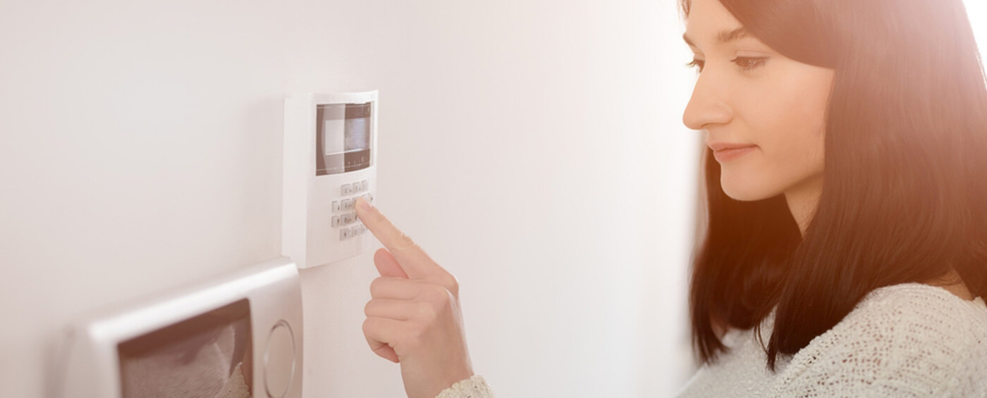 Massachusetts Resident setting an energy efficient thermostat.