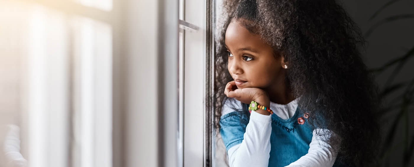 A child looking out energy efficient windows