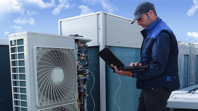 man working with variant refrigerant flow systems equipment